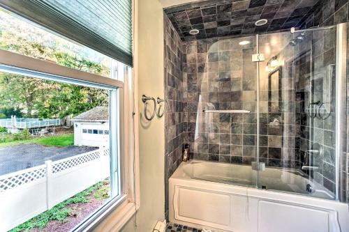 a bathroom with a shower and a window at Pet-Friendly Latham Retreat about 7 Mi to Albany! in Latham