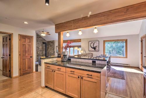 a kitchen with wooden cabinets and a counter top at Cozy Blue River Cabin with Treehouse 6 Mi to Skiing in Blue River
