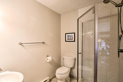 a bathroom with a toilet and a glass shower at Cozy Blue River Cabin with Treehouse 6 Mi to Skiing in Blue River