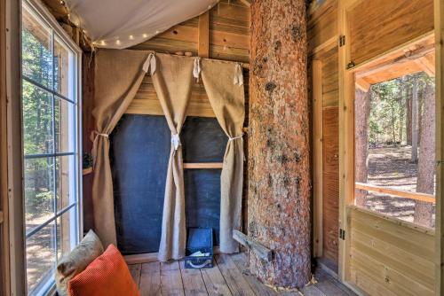 an inside view of a log cabin with a window at Cozy Blue River Cabin with Treehouse 6 Mi to Skiing in Blue River