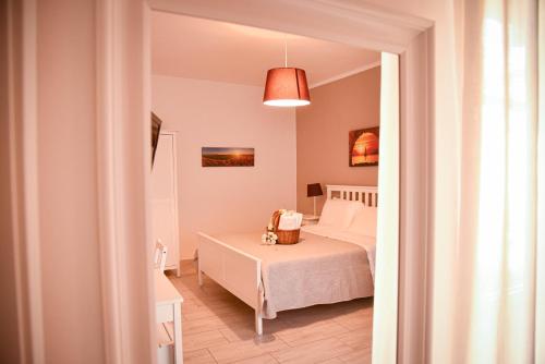 a bedroom with a white bed in a room at A Casa dei Bruno B&B in Pozzuoli