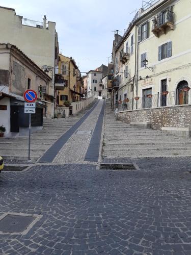 a cobblestone street in a city with buildings at Guidonia Montecelio in Montecelio