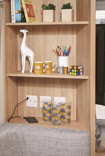 a shelf with a desk with pens and cups on it at Seaton Estate in Arbroath