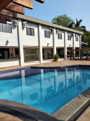 a swimming pool in front of a building at Collina Hotel in Camapuã