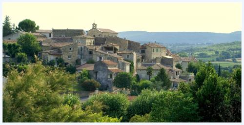 a group of houses on top of a hill at La Maison du Passage - Chambres - Suites premium, Spa, Piscine et Restaurant in Martignargues
