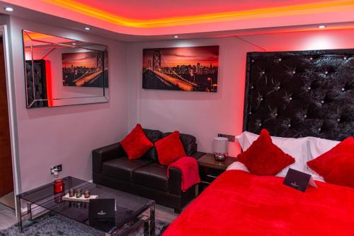 a living room with a couch and red pillows at Meridian Serviced Apartments in Bradford