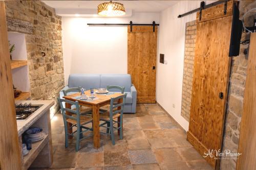a living room with a table and a couch at Al Vico Primo - Rustic Chic Apartment in Pietrapertosa