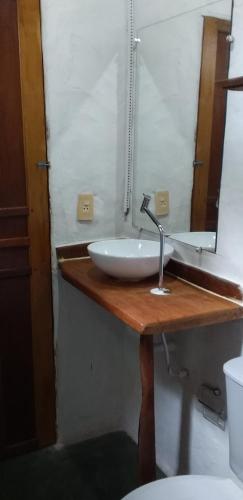 a bathroom with a sink and a mirror at Pousada Aldeia de Morere in Moreré
