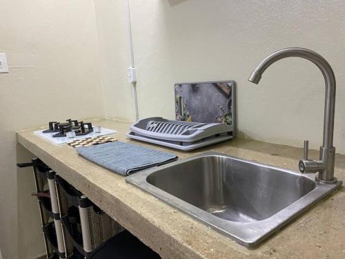 a kitchen counter with a sink and a toaster at Cozy Studio Apartment Minutes from the Beach in Willemstad