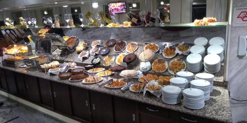 a buffet line with many different types of desserts at Pampas Palace Hotel in São Bernardo do Campo