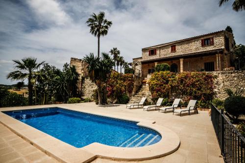 a swimming pool in front of a house at Finca Rural Son Rabassa in Sant Joan