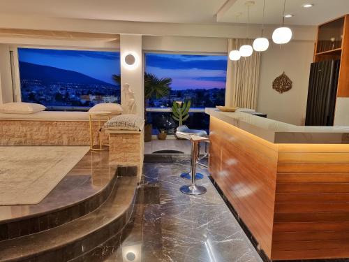 a lobby with a bar with a view of the city at One 360 Skyline Athens Penthouses in Athens