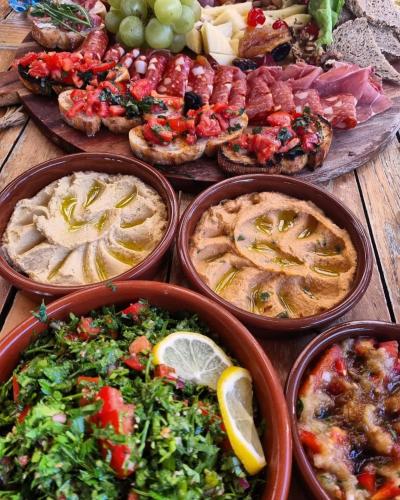 a table full of different types of food on plates at Hotel Coandi in Arad