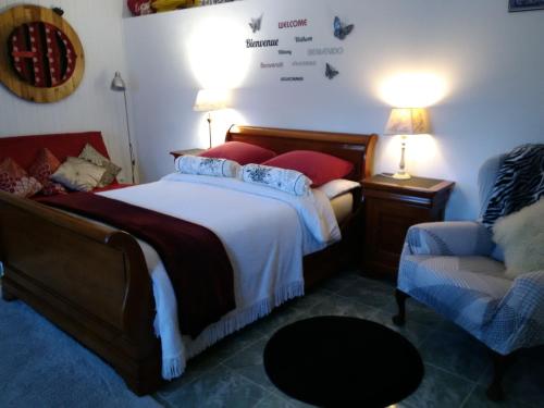 a bedroom with a bed and a couch and a chair at Four chimneys in Treffrin