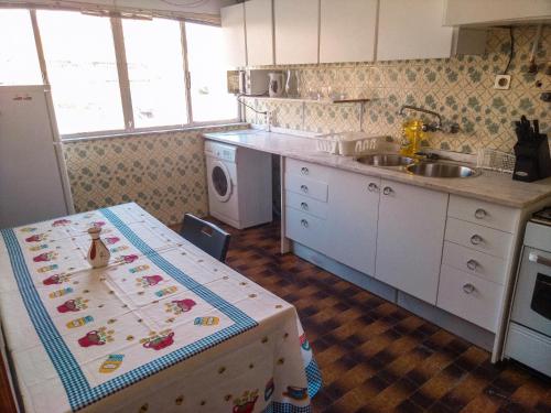 a kitchen with a table and a sink at Enjoy Braga Estação - Charming Bedrooms in the Historic Center in Braga