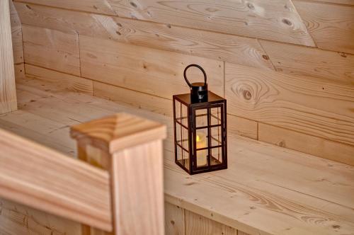 a lantern in a room with wooden walls at Jędroskowe Chatki in Witów
