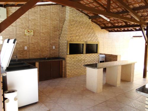 a large kitchen with a counter top in a room at Casa com piscina para família in Florianópolis