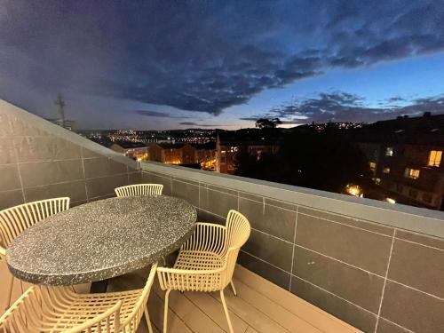 a table and chairs on a balcony with a view at Oktheway Areal Terrace in Oleiros