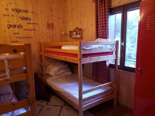 a room with two bunk beds and a window at Chalet le 22 Agniéres in Le Dévoluy