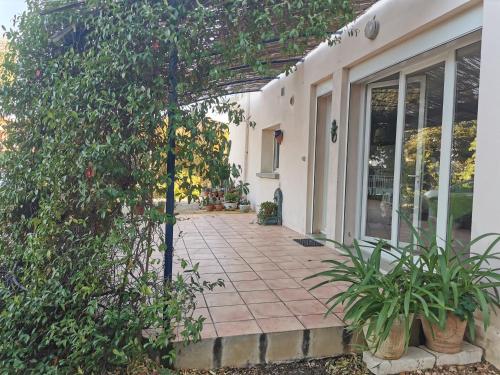 a house with a walkway leading to a patio at Un coin de campagne à 4km de la mer pour 4 à 6 personnes in Portiragnes