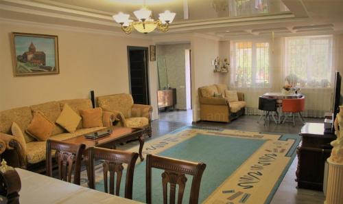 a living room with a couch and a table at Armen's B&B in Sevan