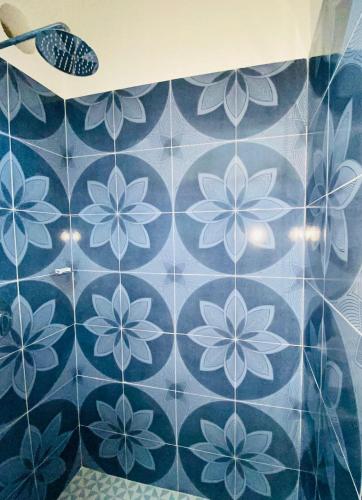 a blue tiled wall with a flower pattern on it at The Quetzal in Cancún
