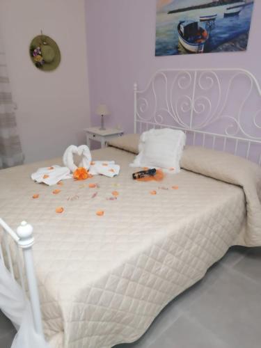 a white bed with flowers on it in a bedroom at B&B Petra Hercules in Torre Annunziata