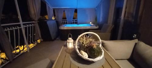 a room with a table with a basket and a tub at Apartments Anita Frane in Vodice