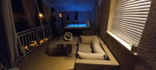 a room with a couch and a table on a balcony at Apartments Anita Frane in Vodice