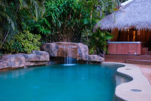 a swimming pool with a waterfall in a resort at Sandalwood in Avoca Beach