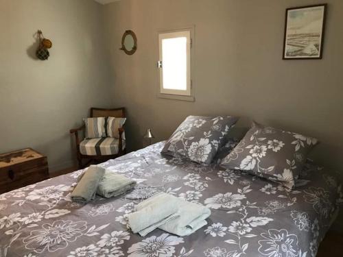 1 dormitorio con 1 cama con 2 toallas en St Mart. l'îlot Rhéa, en Saint-Martin-de-Ré