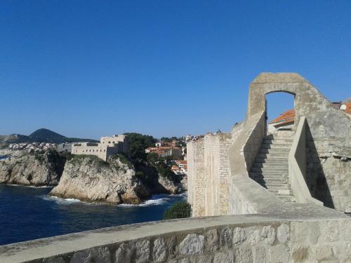 a bridge over a body of water with stairs at Old Harbour City Center Apartment in Dubrovnik