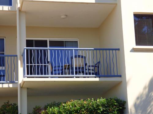 a balcony of a house with a blue railing at Villa Mar Colina in Yeppoon