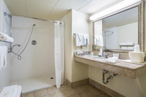 a bathroom with a shower and a sink at Quality Inn North Battleboro in Battleboro