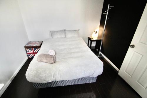 a bedroom with a large white bed in a room at The Parkdale Hostellerie in Toronto