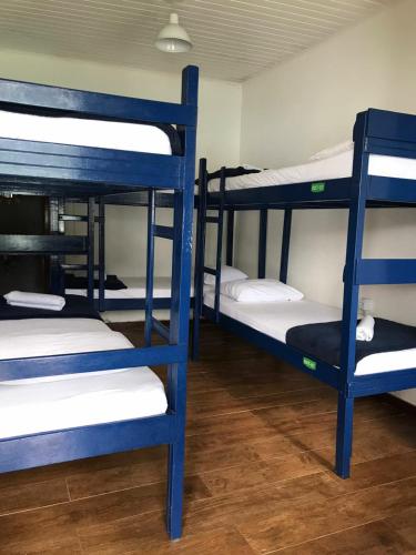 a group of bunk beds in a room at Aquario Pousada Hostel - Night Club in Abraão