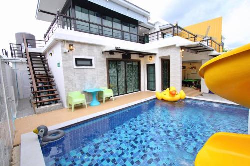 a house with a swimming pool in front of a house at Boutique Huahin Pool Villa in Hua Hin