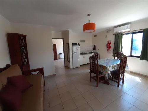 a kitchen and dining room with a table and chairs at Ayres Del Rio Uruguay in Colón