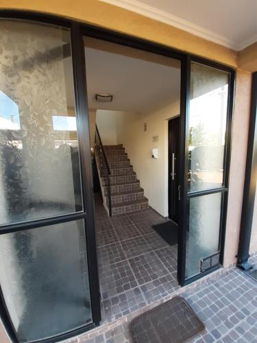 an entrance to a house with glass doors at Ayres Del Rio Uruguay in Colón