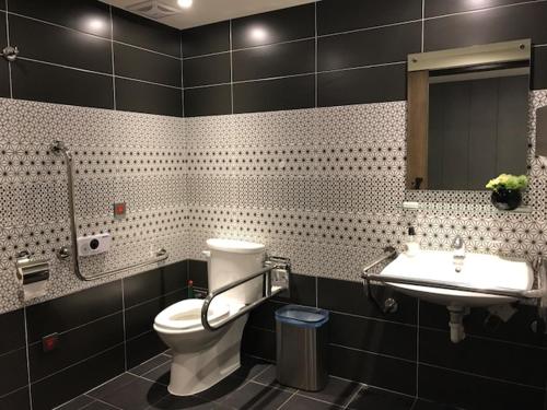 a bathroom with a toilet, sink, and bathtub at Ximen Hotel in Taipei