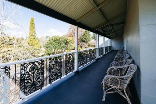 a row of chairs sitting on a balcony at Hotel Etico at Mount Victoria Manor in Mount Victoria