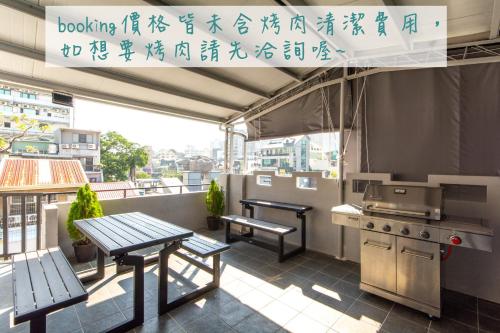 a kitchen with a grill and a table and benches at W Cube in Tainan