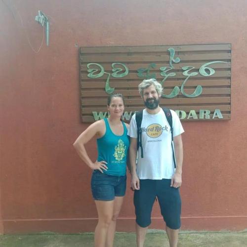 a man and a woman standing in front of a building at Serenity Lake Resort Yala in Tissamaharama
