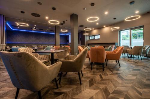 a restaurant with tables and chairs in a room at Wellness Hotel Panorama in Trenčianske Teplice
