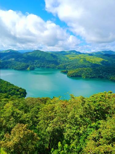 a view of a lake in the hills at Eden Homestay Idukki in Idukki