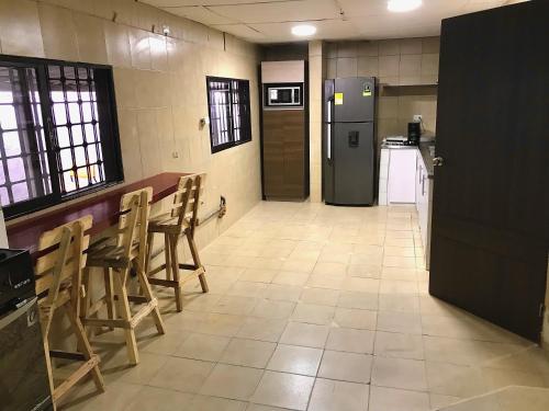 a kitchen with a table and chairs and a refrigerator at La Quinta Bacana La Campiña in Barranquilla