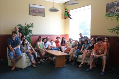 a group of people sitting on couches in a room at Hotel Erfolg in Daugavpils