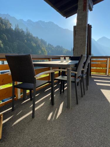 a table and chairs on a balcony with a view at Appartement Schillerkopf in Bludenz
