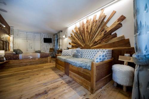 a bedroom with a bed with a large wooden headboard at Le Relais du Boucher in Gaby