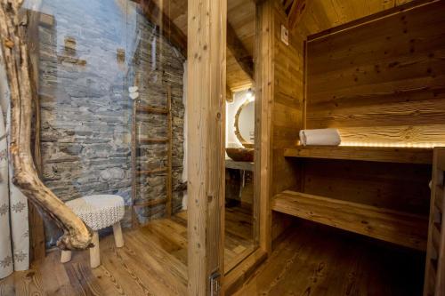 a wooden cabin with a sauna with a chair in it at Le Relais du Boucher in Gaby